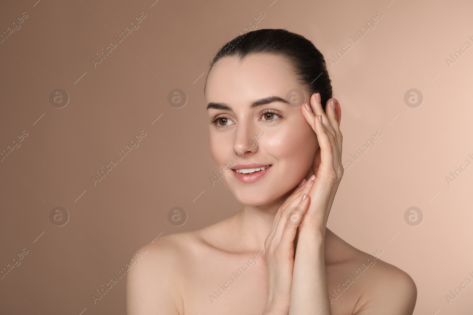 Photo of Portrait of beautiful young woman on light brown background. Space for text