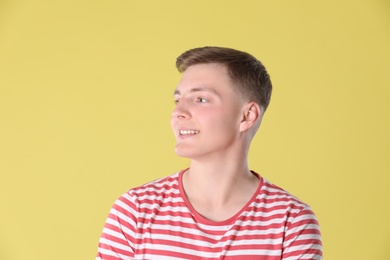 Photo of Portrait of teenage boy on yellow background