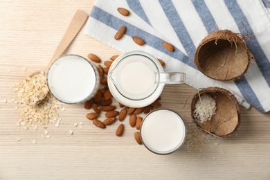Composition with different types of milk on wooden background