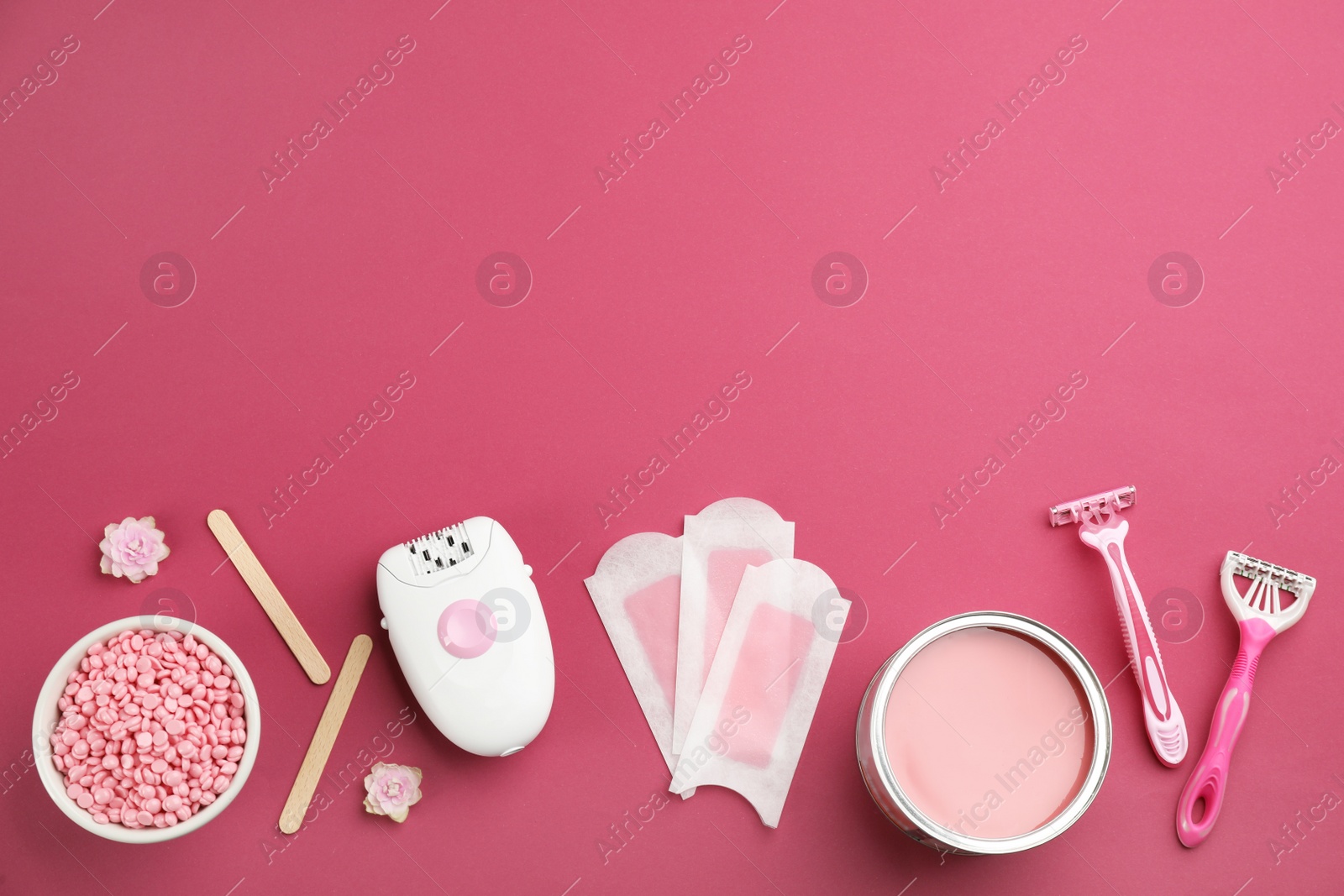 Photo of Set of epilation products on crimson background, flat lay. Space for text