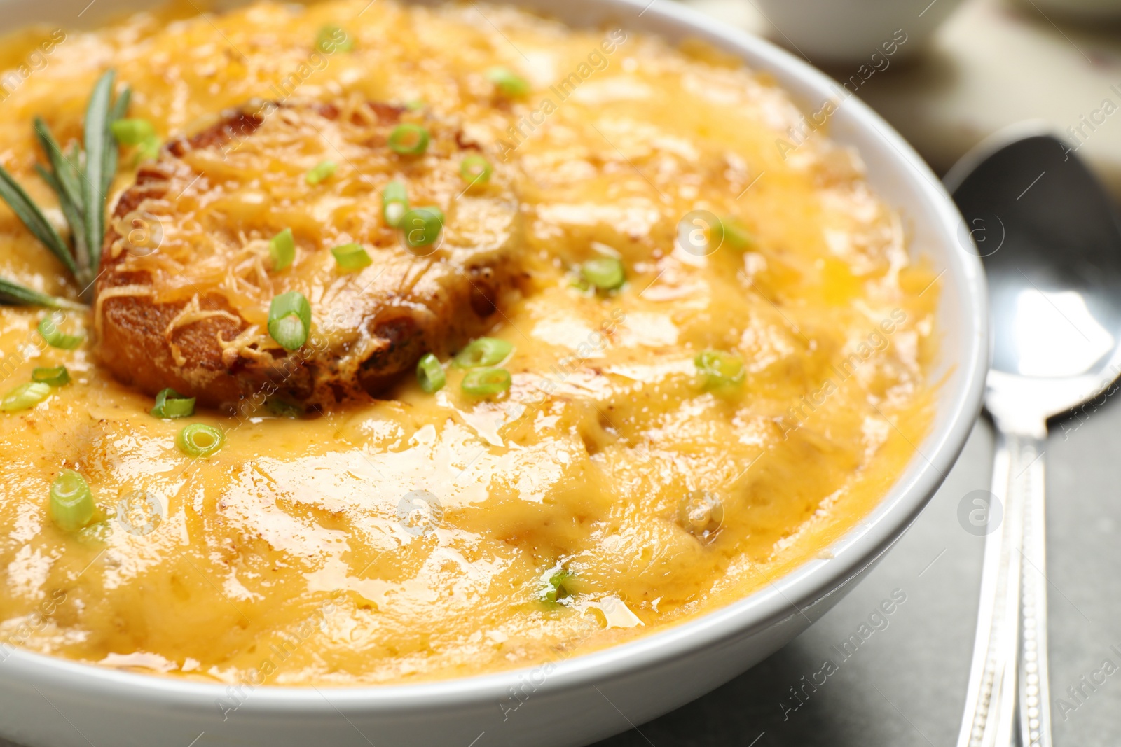 Photo of Tasty homemade French onion soup in bowl, closeup