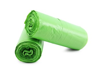 Photo of Two rolls of light green garbage bags isolated on white