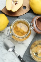 Photo of Delicious quince drink and fresh fruits on white marble table, flat lay