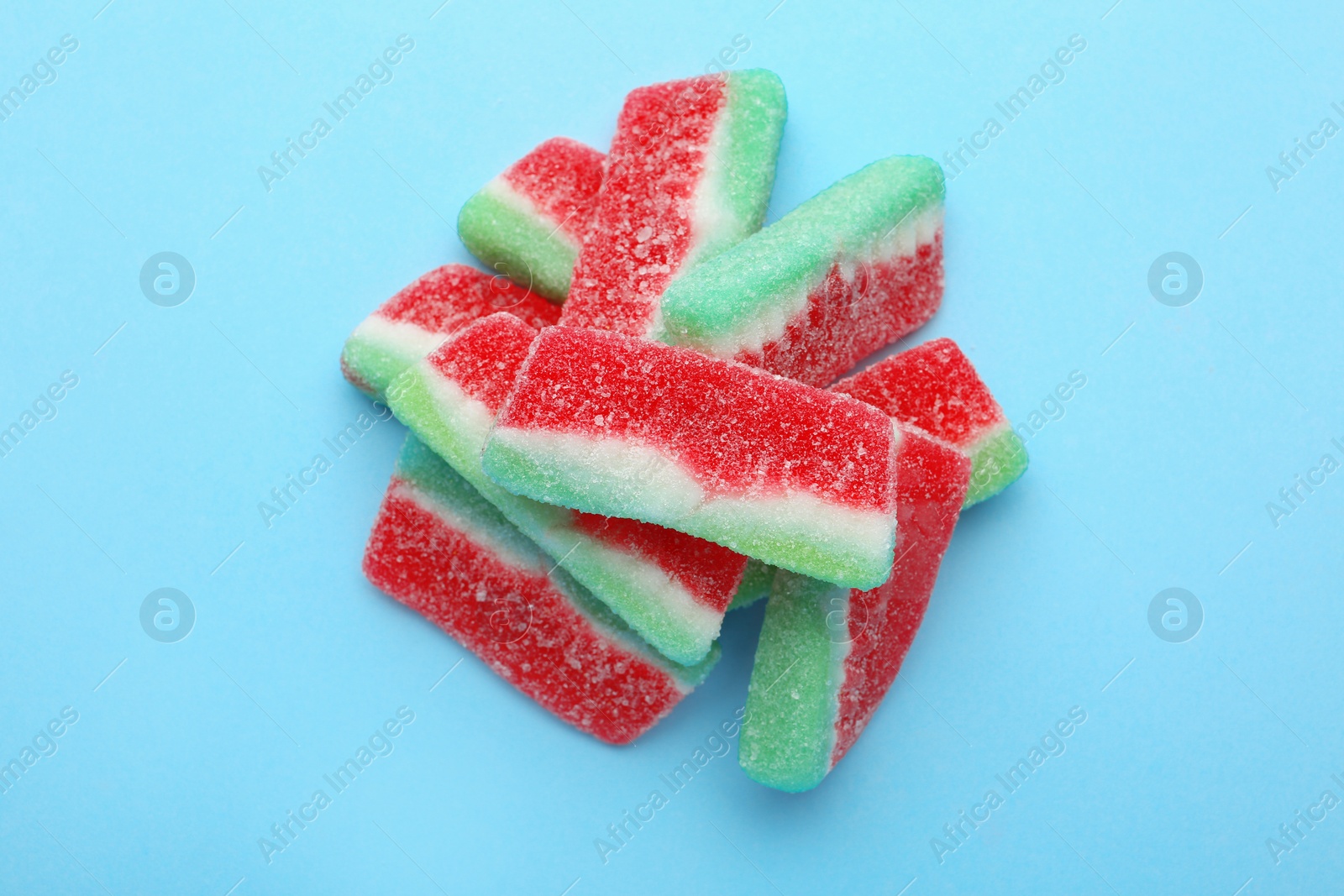 Photo of Pile of tasty jelly candies on color background, top view