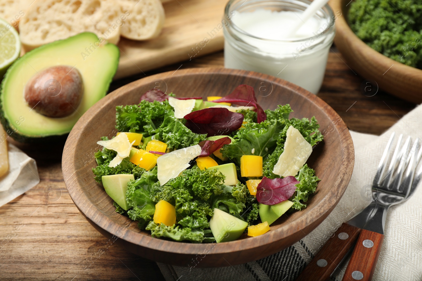 Photo of Delicious kale salad served on wooden table