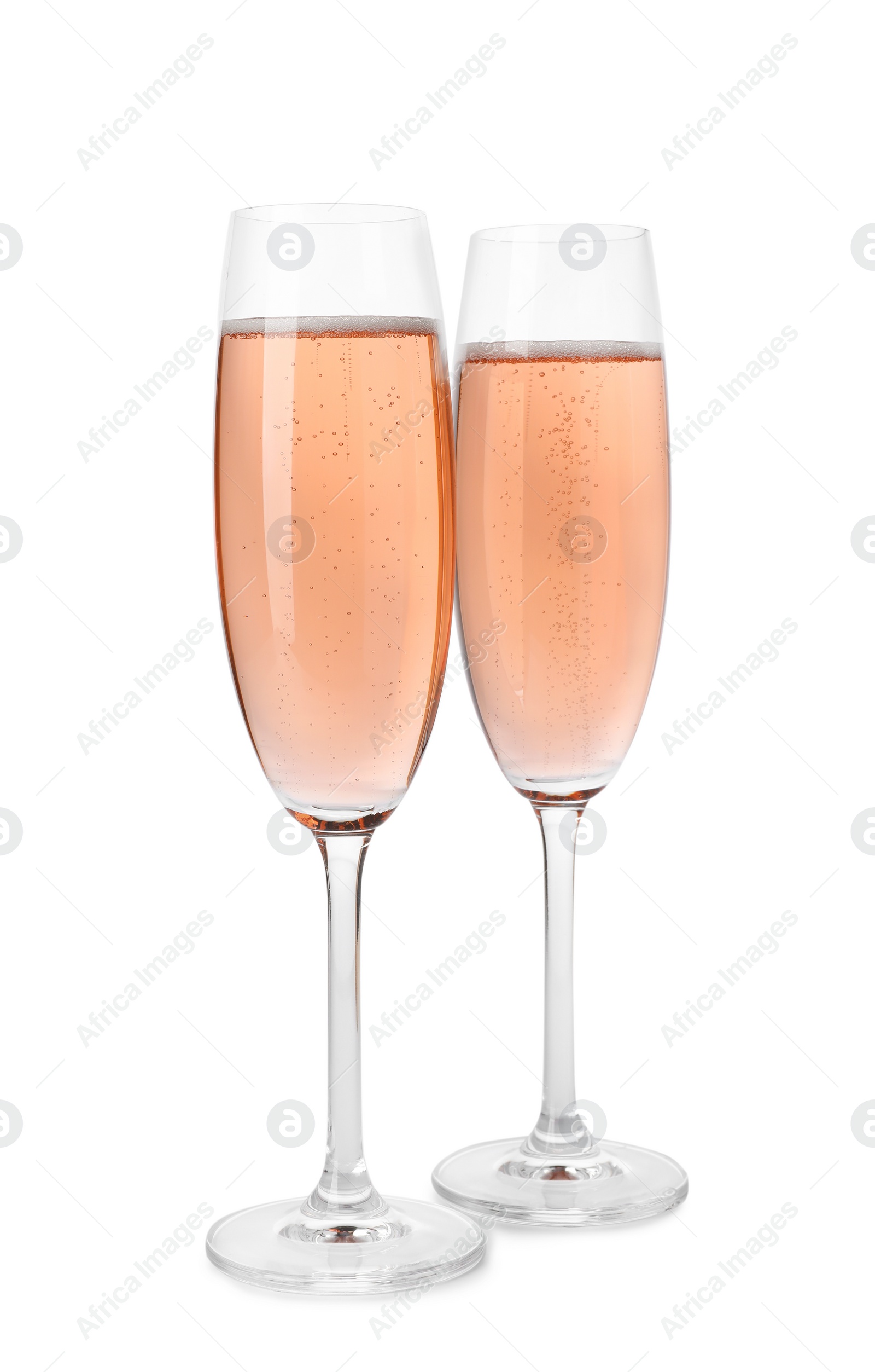 Photo of Glasses of rose champagne isolated on white