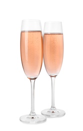 Photo of Glasses of rose champagne isolated on white