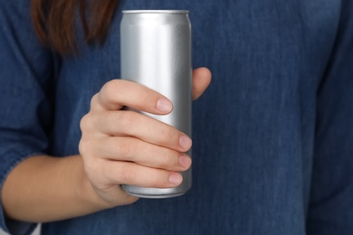 Photo of Woman holding aluminum can, closeup. Space for design