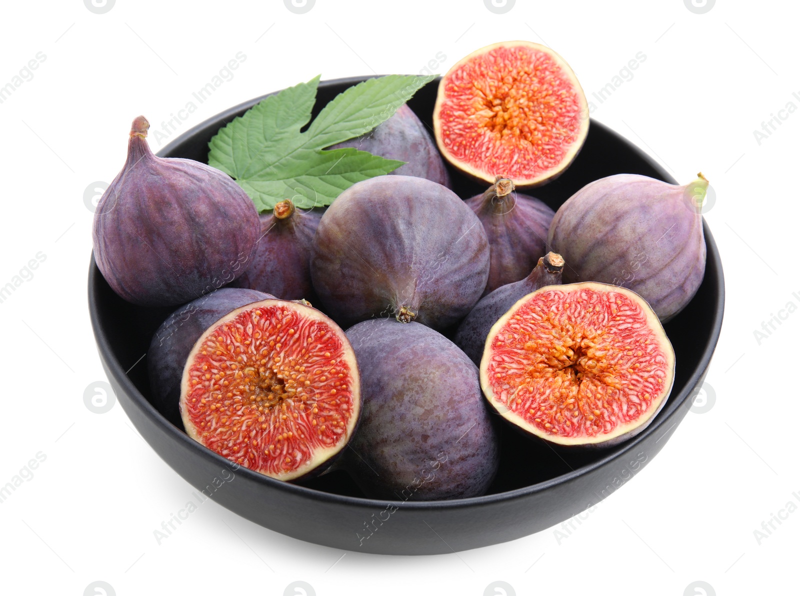 Photo of Whole and cut fresh purple figs in bowl isolated on white