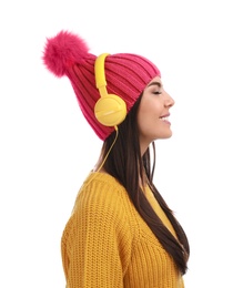 Young woman listening to music with headphones on white background