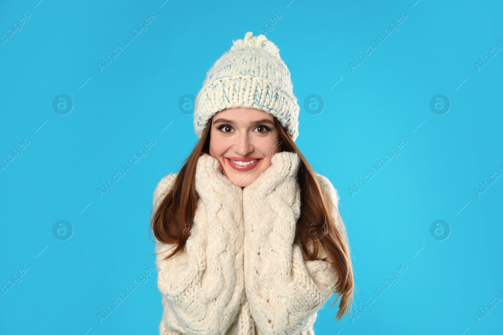 Photo of Young woman wearing Christmas sweater on blue background