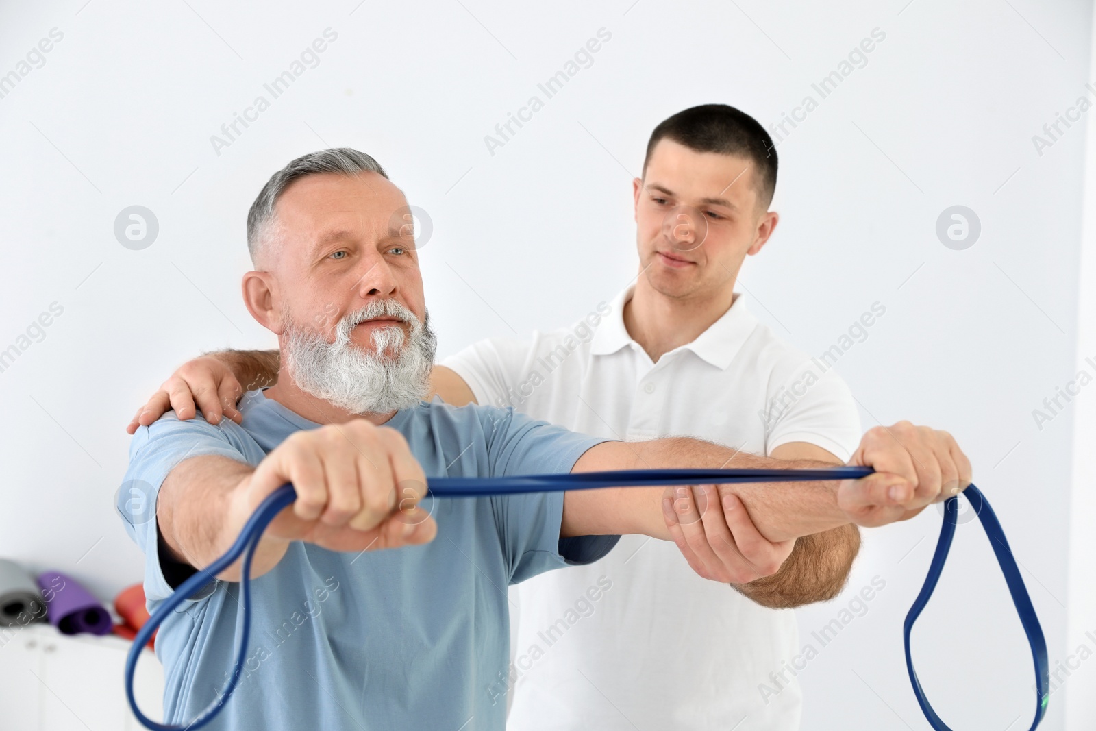 Photo of Professional physiotherapist working with senior patient in rehabilitation center