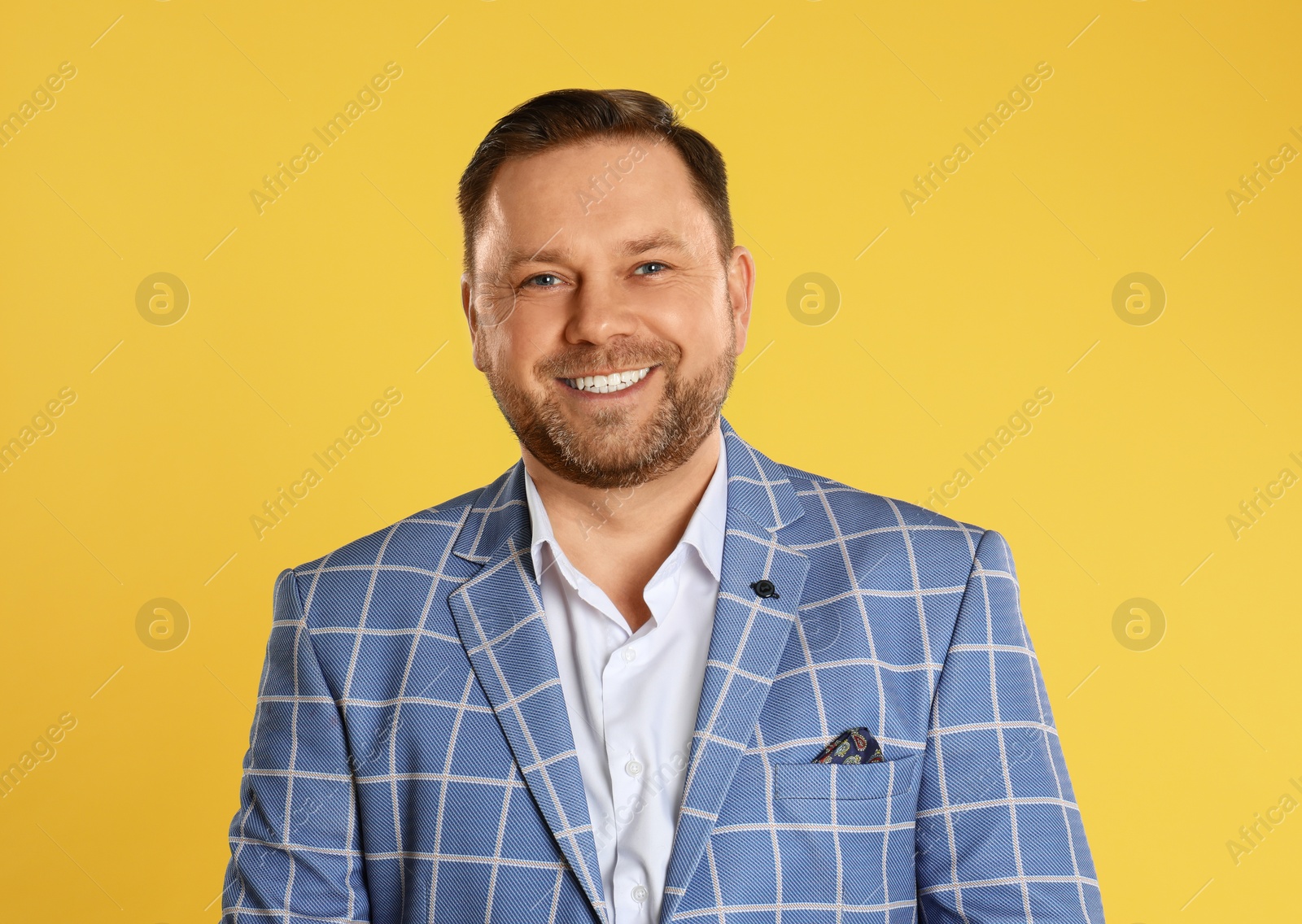 Photo of Portrait of happy mature man on yellow background