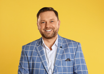 Photo of Portrait of happy mature man on yellow background