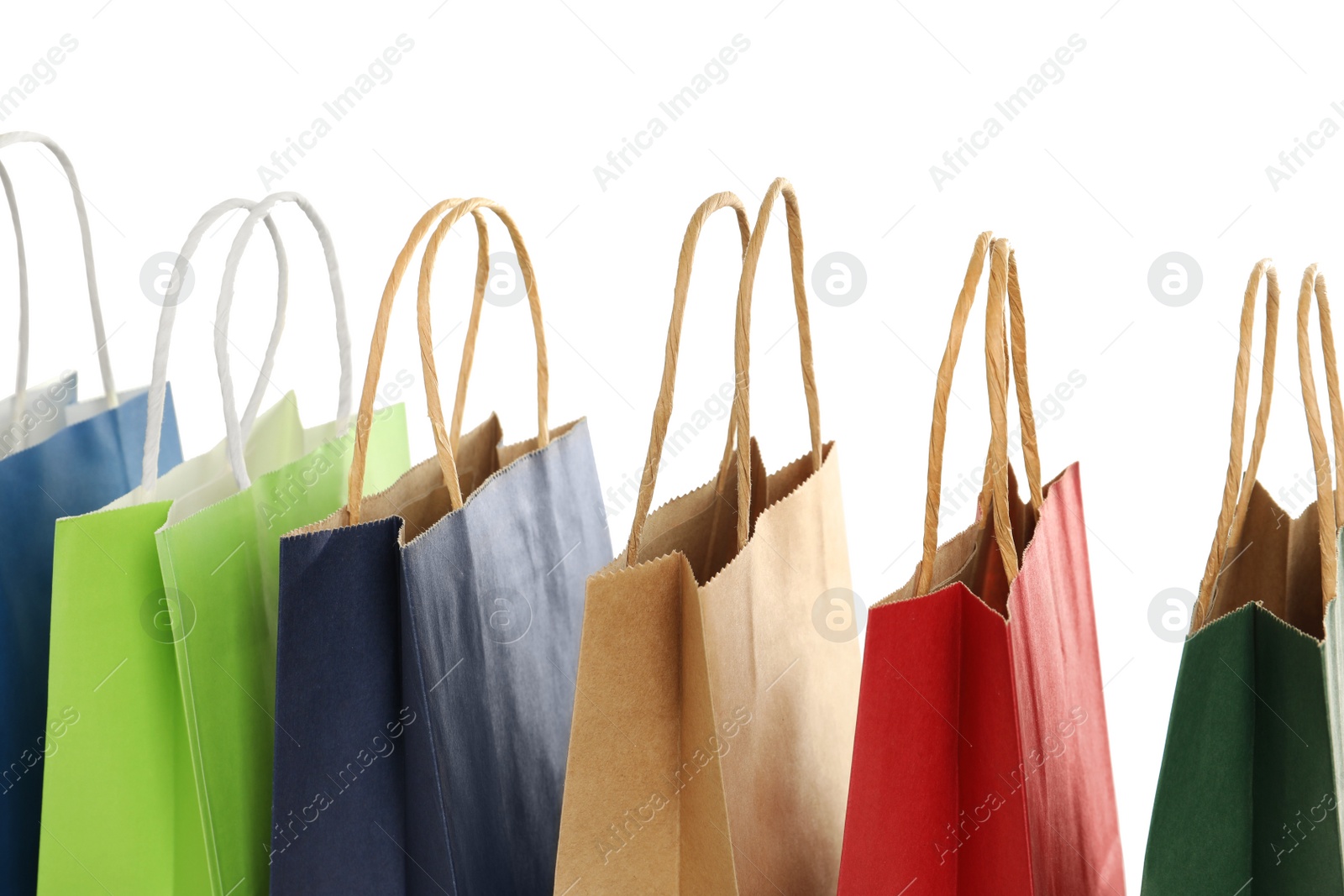 Photo of Colorful paper shopping bags on white background