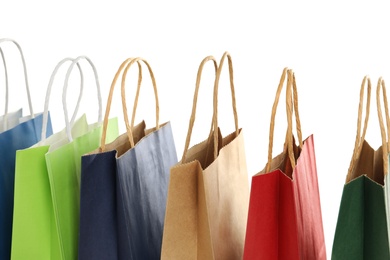 Photo of Colorful paper shopping bags on white background