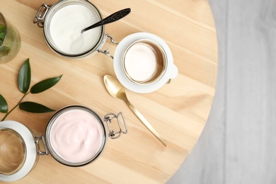 Photo of Jars with different yogurts on table