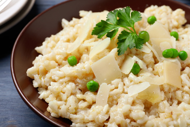 Photo of Delicious risotto with cheese in plate, closeup