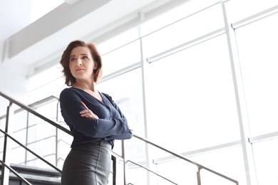 Photo of Female lawyer standing near stairs in office