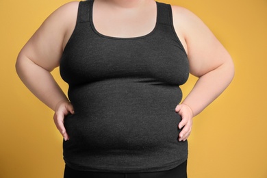 Overweight woman on color background