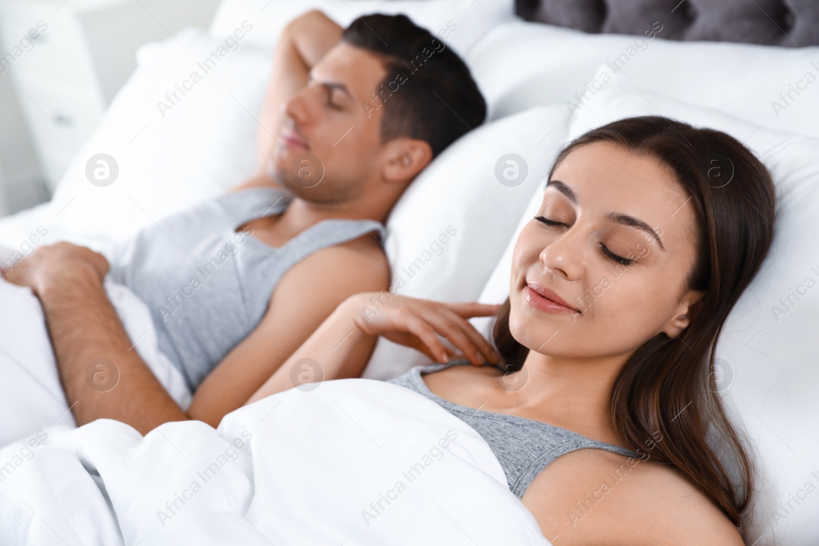 Photo of Portrait of lovely couple sleeping in large bed