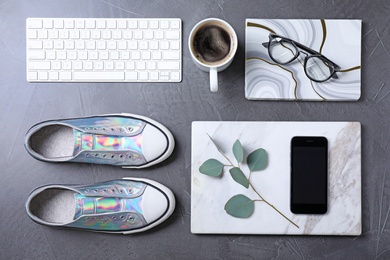 Flat lay composition with keyboard and fashion blogger's stuff on stone surface