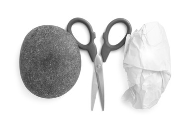 Photo of Rock, crumpled paper and scissors on white background, top view