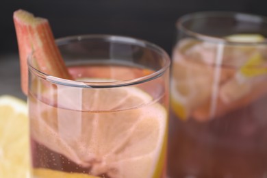 Photo of Glass of tasty rhubarb cocktail with lemon, closeup