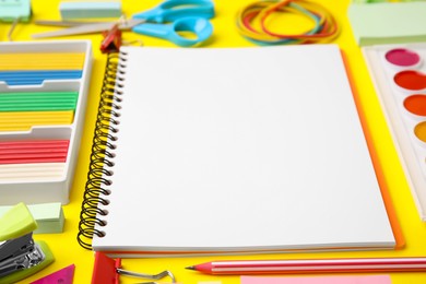 Photo of Different school stationery on yellow background, closeup. Back to school
