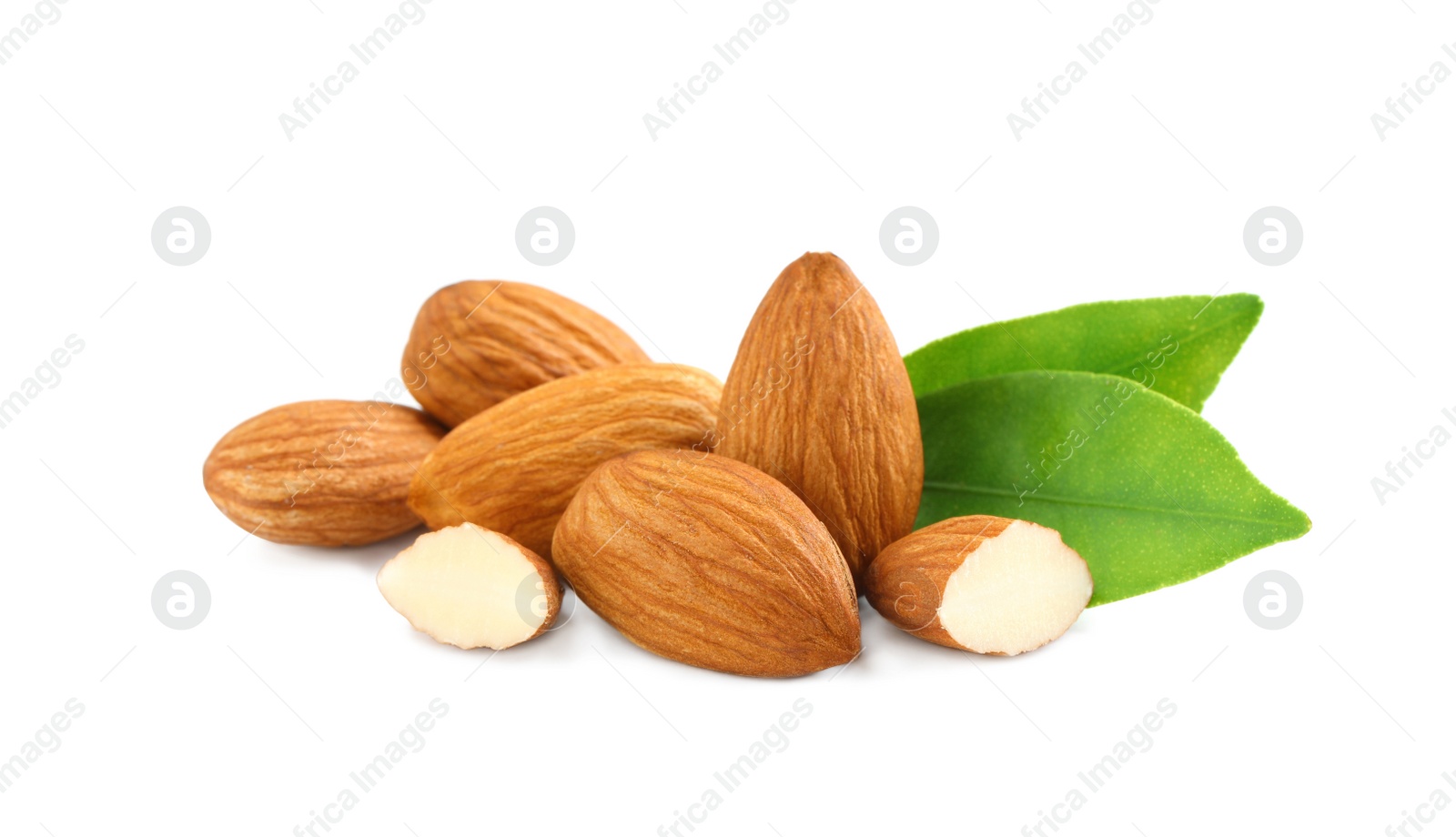 Photo of Organic almond nuts and green leaves on white background. Healthy snack