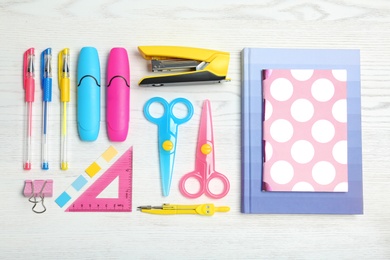 Photo of Flat lay composition with different school stationery on wooden background