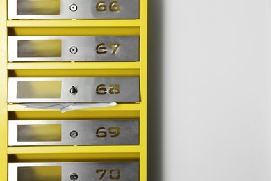 Photo of Metal mailboxes with keyholes, numbers and receipts in post office, space for text