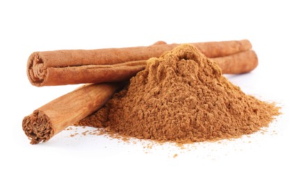 Photo of Dry aromatic cinnamon sticks and powder isolated on white