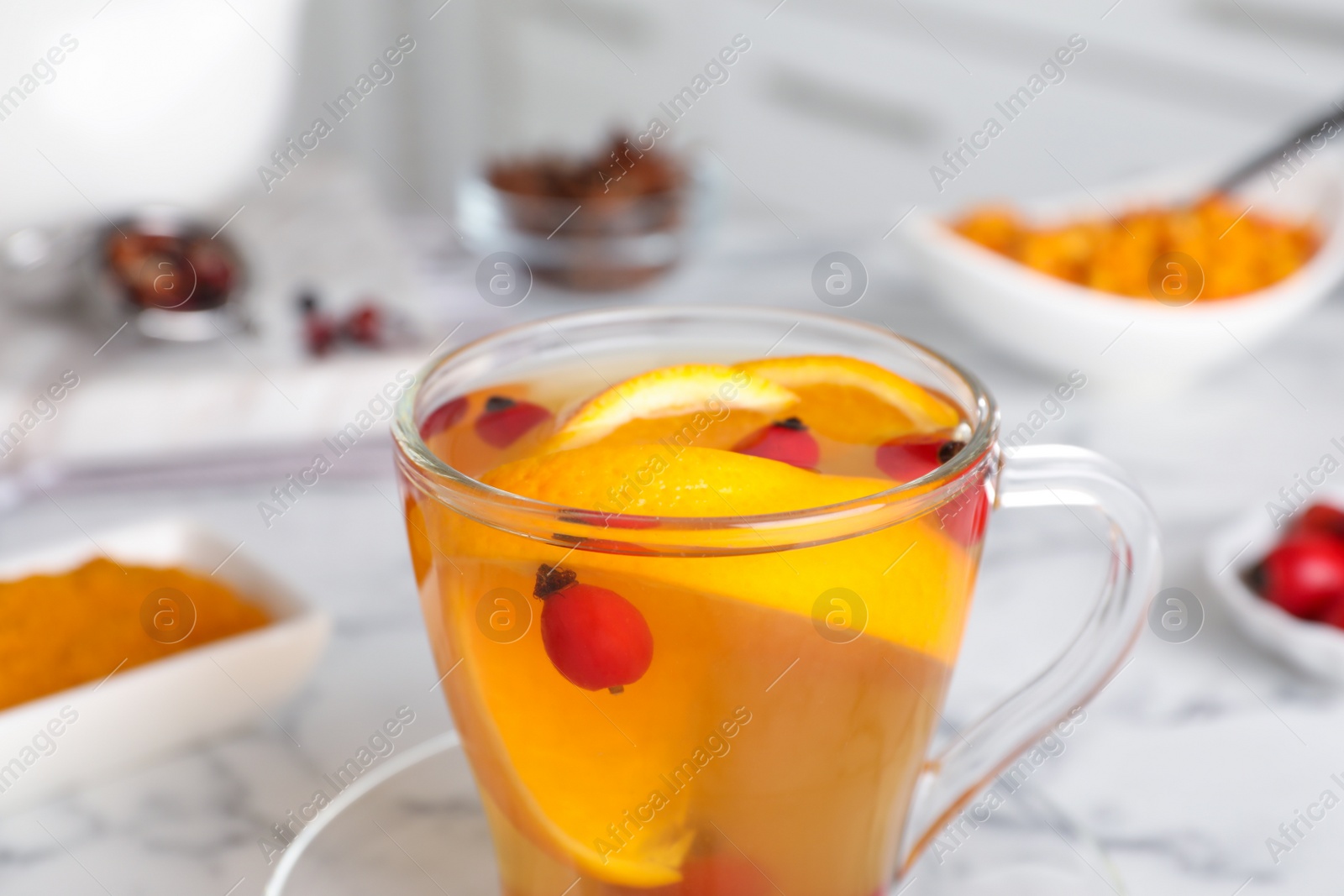Photo of Immunity boosting drink on white marble table, closeup