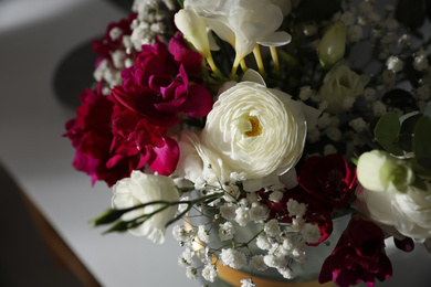 Photo of Beautiful bouquet with spring freesia flowers on white table, closeup