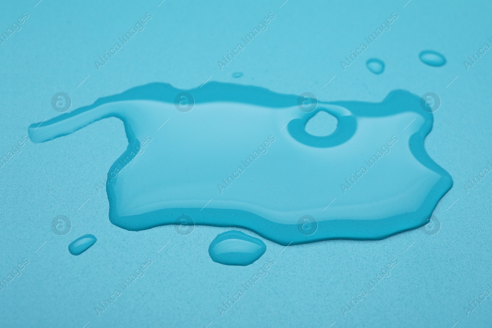 Photo of Puddle of water on light blue background