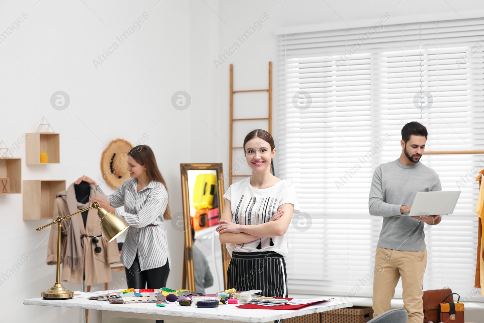 Photo of Fashion designers creating new clothes in studio