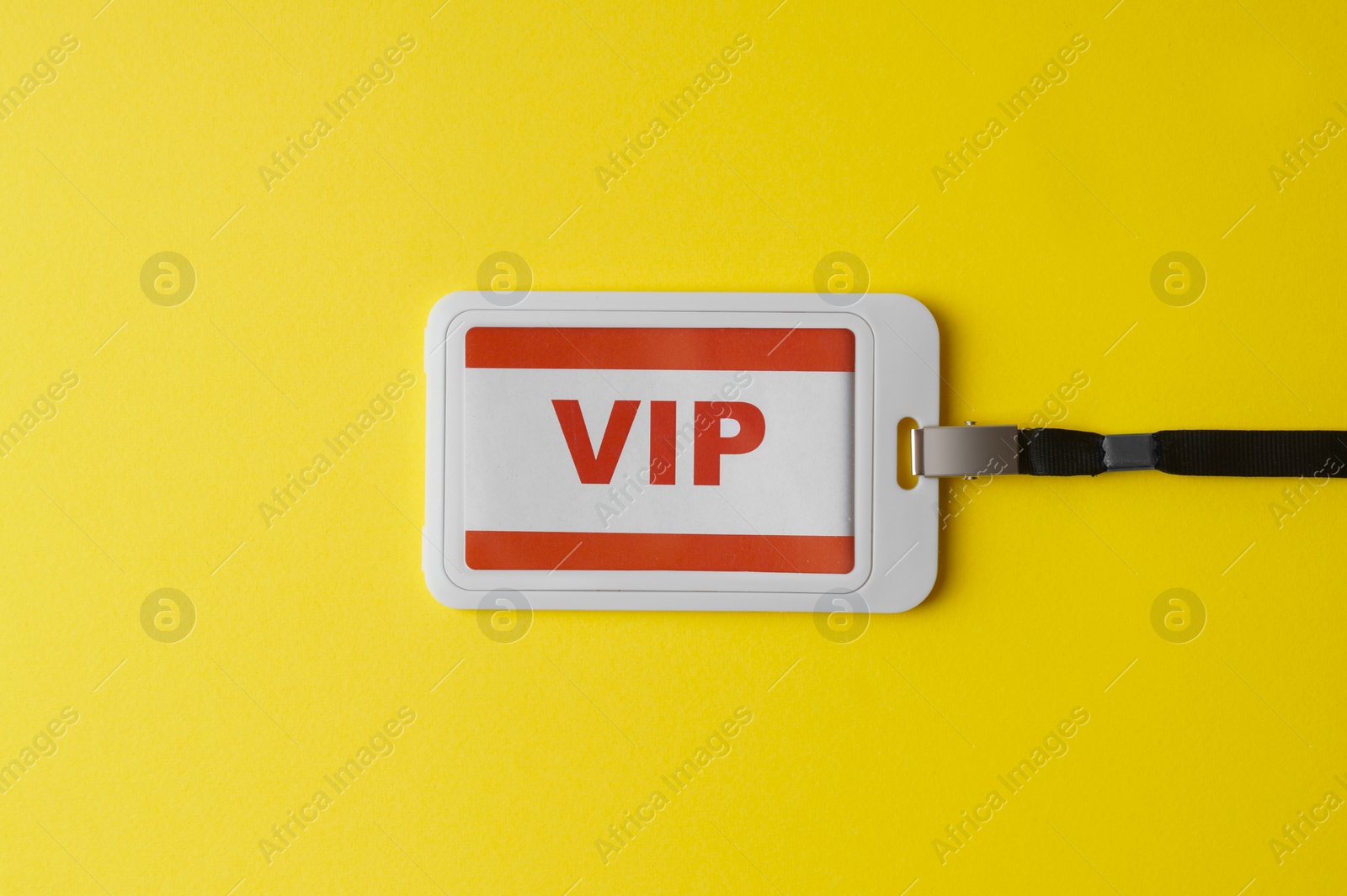 Photo of Vip badge on yellow background, top view