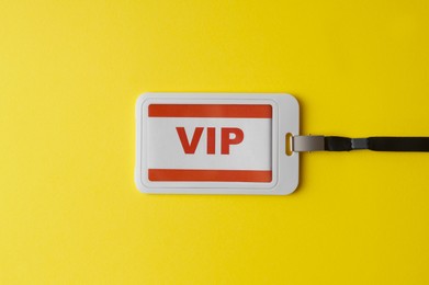 Photo of Vip badge on yellow background, top view