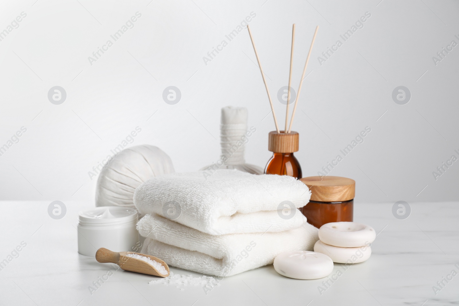 Photo of Spa composition with care products on white marble table