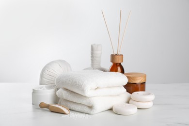 Photo of Spa composition with care products on white marble table