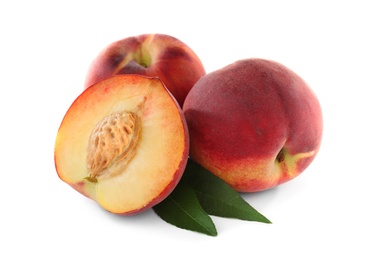 Photo of Sweet juicy peaches with leaves on white background