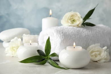 Photo of Beautiful spa composition with candles and flowers on table