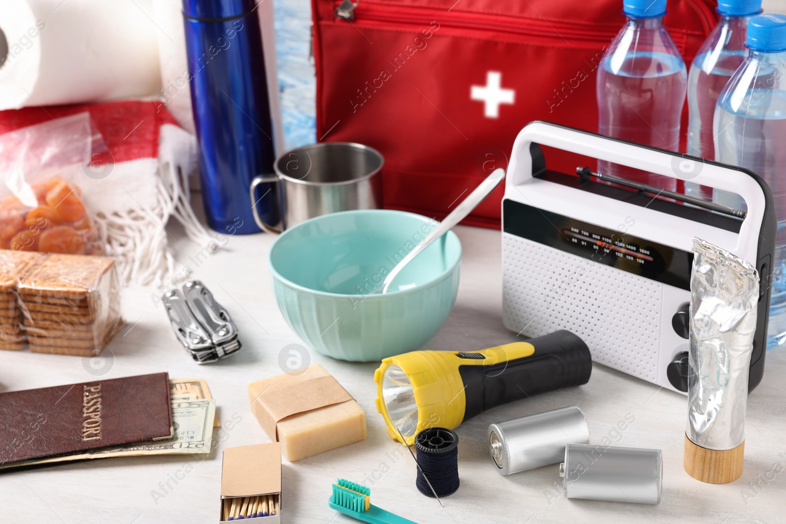 Photo of Disaster supply kit for earthquake on white wooden table