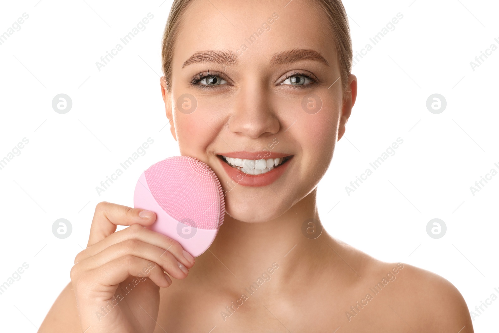 Photo of Young woman washing face with cleansing brush on white background. Cosmetic product