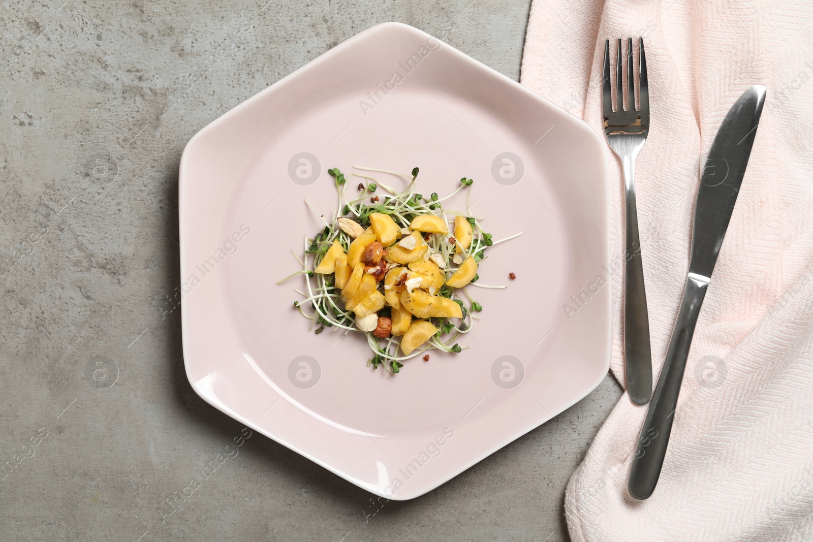 Photo of Delicious fresh carrot salad served on grey table, flat lay