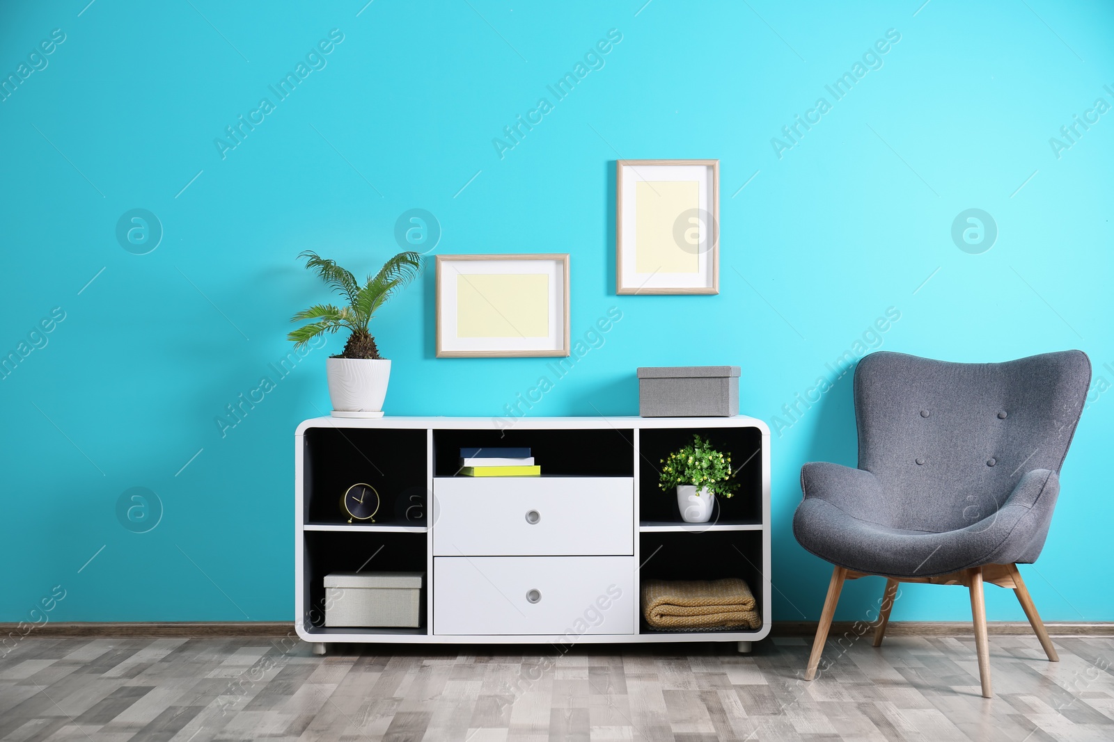 Photo of Elegant room interior with stylish shelving unit and armchair