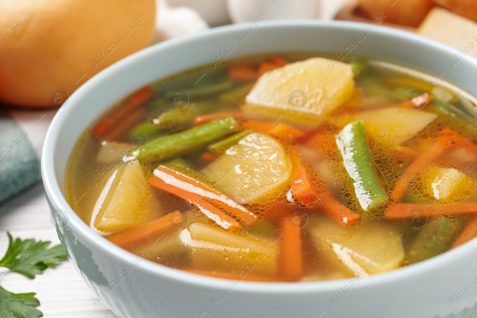 Photo of Bowl of tasty turnip soup on table, closeup