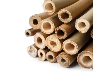 Photo of Pile of dry bamboo sticks on white background