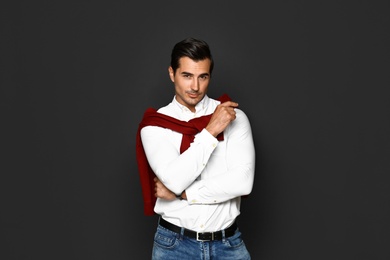 Portrait of handsome young man on dark background